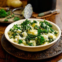 Cauliflower and potato mash with kale and melting brie